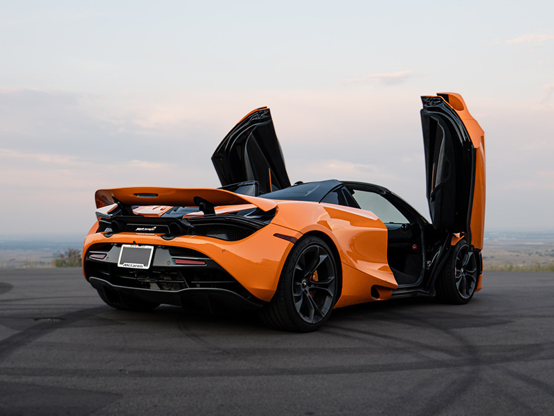 Orange McLaren 720s side view doors open