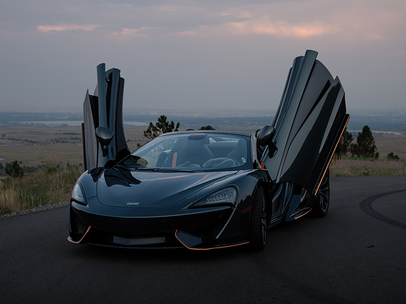 Black McLaren 570s Spider with doors open